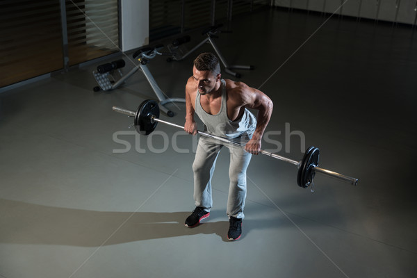 Człowiek wykonywania powrót sztanga sportu siłowni Zdjęcia stock © Jasminko
