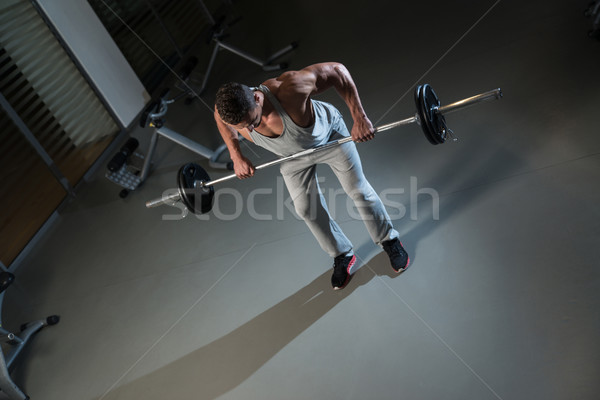 Man Doing Exercise For Back With Barbell Stock photo © Jasminko