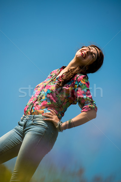 beautiful woman in jeans standing on the grass Stock photo © Jasminko