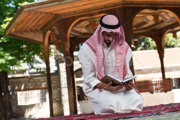 Muslim Man In Dishdasha Is Reading The Quran Stock photo © Jasminko