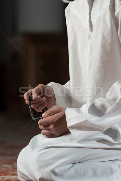 Stock photo: Close-Up Of Male Hands Praying With Rosary