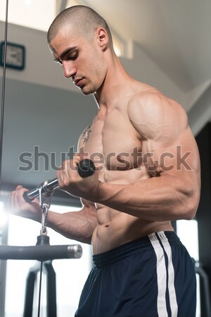 Young Man Working Out In A Health Club Stock photo © Jasminko
