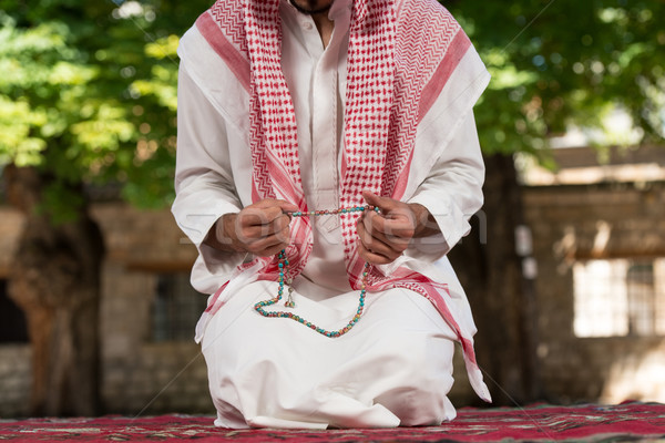 Close-Up Of Male Hands Praying With Rosary Stock photo © Jasminko