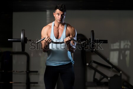 Stock photo: Men In The Gym Exercising Biceps With Barbell