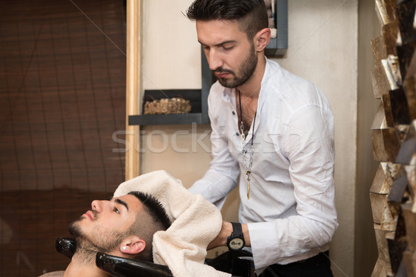 Washing Man Hair In Beauty Parlour Hairdressing Salon Stock photo © Jasminko