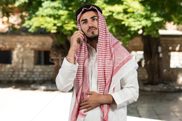 Cheerful Muslim Man Talking On Cell Phone Stock photo © Jasminko