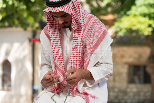 Stock photo: Close-Up Of Male Hands Praying With Rosary