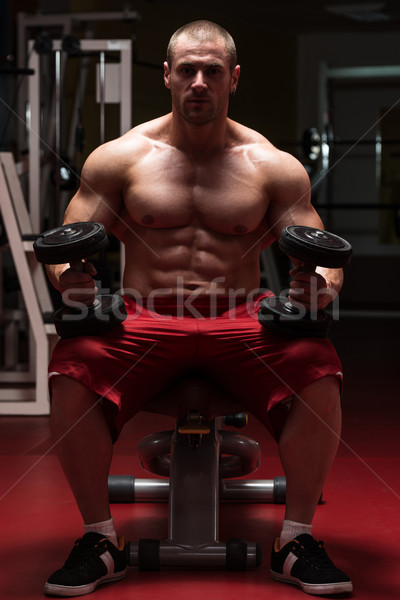 Young Man Doing Exercise For Biceps Stock photo © Jasminko