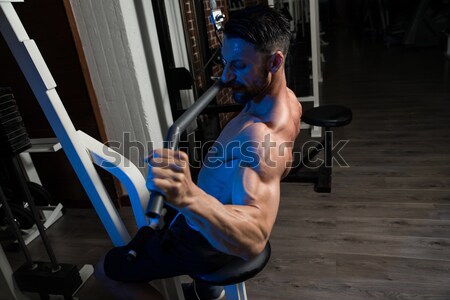 male bodybuilder resting after doing heavy weight exercise Stock photo © Jasminko