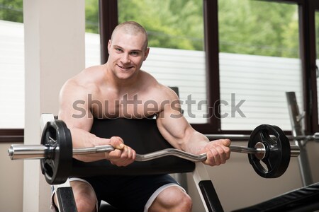 Stock photo: Men In The Gym Exercising Biceps With Barbell