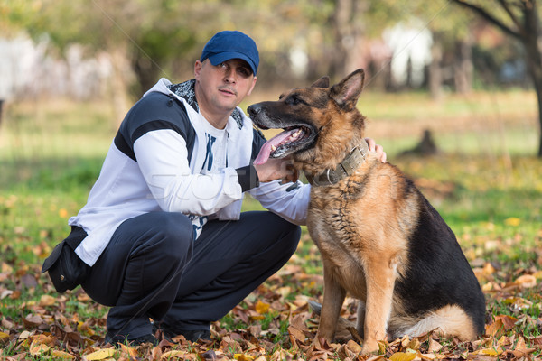 Adult Man Sitting Outdoors With His German Shepherd Stock photo © Jasminko