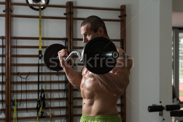 Healthy Man Working Out Biceps In A Health Club Stock photo © Jasminko