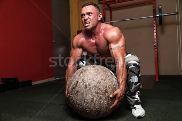 Bodybuilder Trying To Pick Up A Stone Stock photo © Jasminko