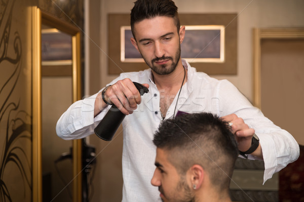 Male Hairstylist Water Sprayer On Hair On Hair Stock photo © Jasminko