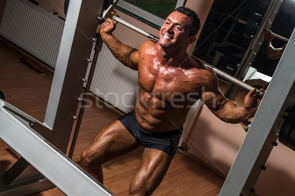 Bodybuilder bilanciere uomo corpo palestra ritratto Foto d'archivio © Jasminko