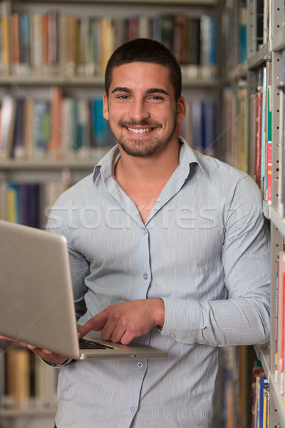 Fiatal diák laptopot használ könyvtár jóképű férfi Stock fotó © Jasminko