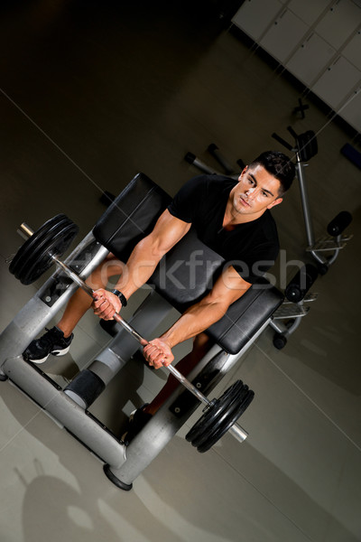 Handsome muscular man exercising in Gym Stock photo © Jasminko