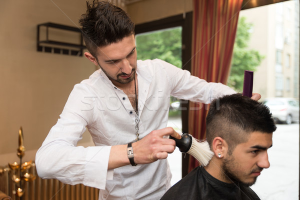 Hairdresser Making Haircut To Young Man Stock Photo C Jasminko