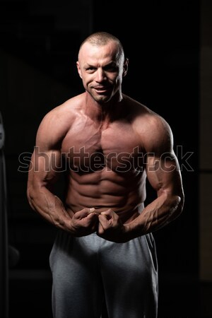 Handsome Body Builder Making Most Muscular Pose Stock photo © Jasminko