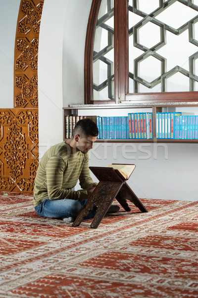Stock photo: Young Muslim Guy Reading The Koran