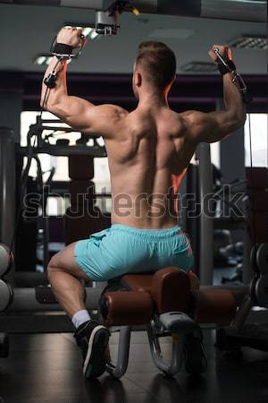 Hombro ejercicio hombre maduro gimnasio oscuro masculina Foto stock © Jasminko