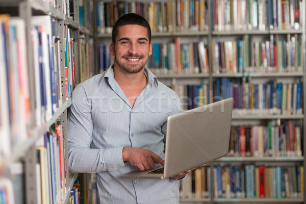 Feliz masculino estudante laptop biblioteca bonito Foto stock © Jasminko