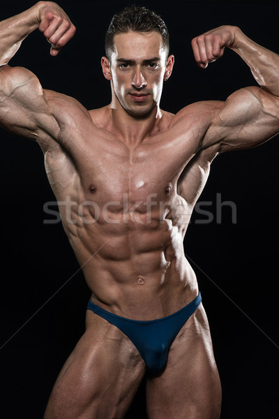 Young Bodybuilder Flexing Muscles Isolate On Black Blackground Stock photo © Jasminko