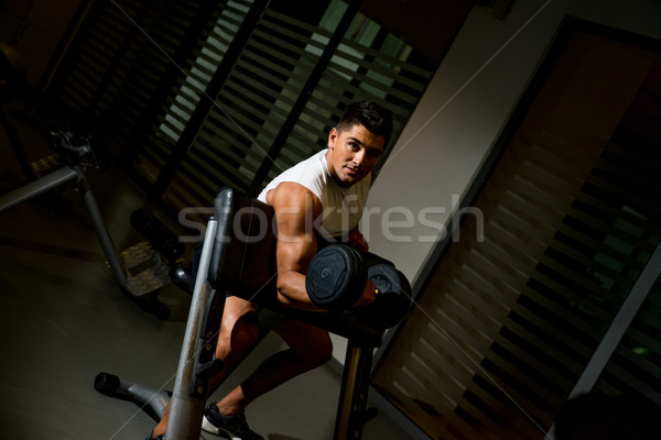Man lifting dumbell in gym Stock photo © Jasminko