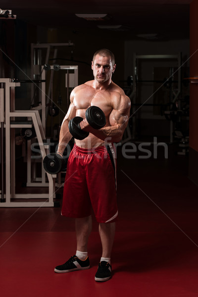 Egészséges fiatalember testmozgás bicepsz testépítő edz Stock fotó © Jasminko