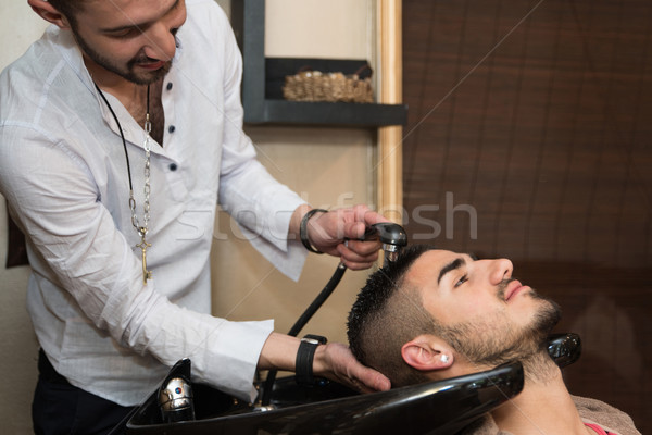 Washing Man Hair In Beauty Parlour Hairdressing Salon Stock photo © Jasminko