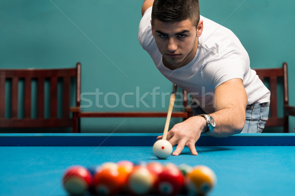 Young Men Lining To Hit Ball On Pool Table Stock photo © Jasminko