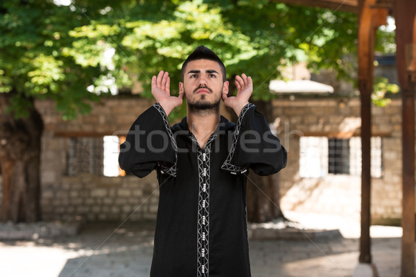 Muslim Man In Dishdasha Is Praying In The Mosque Stock photo © Jasminko