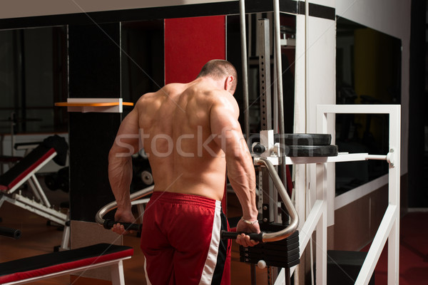 Young Bodybuilder Doing Heavy Weight Exercise For Trapezius Stock photo © Jasminko