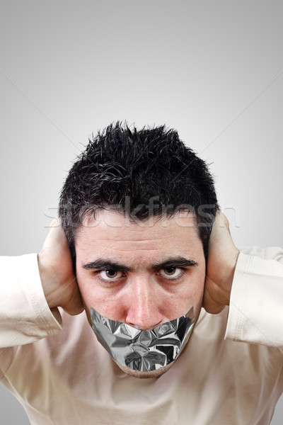 Angry young man having gray duct tape on his mouth Stock photo © jaycriss