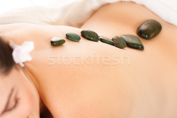 Fit woman getting a hot stone massage Stock photo © jaykayl