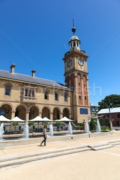 Stock photo: Woman walking in Newcastle past Customs House