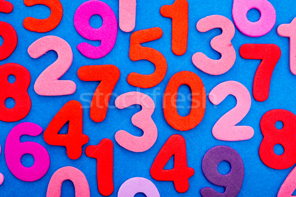 Variety of Numbers in red and pink on blue Stock photo © JFJacobsz