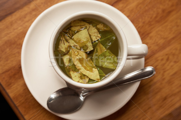 Stock photo: Cup of Coca Tea on Wooden table.