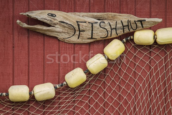 Sign on house of fisherman with net Stock photo © jirivondrous