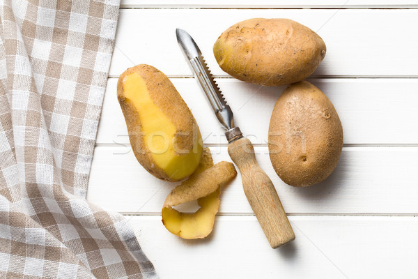 wooden peeler and potatoes Stock photo © jirkaejc