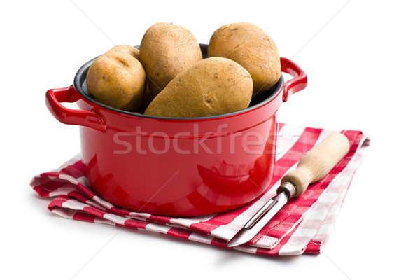 uncooked potatoes and old wooden peeler Stock photo © jirkaejc