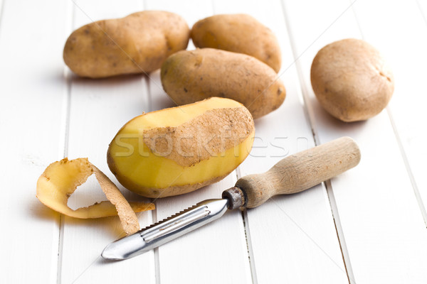 wooden peeler and potatoes Stock photo © jirkaejc