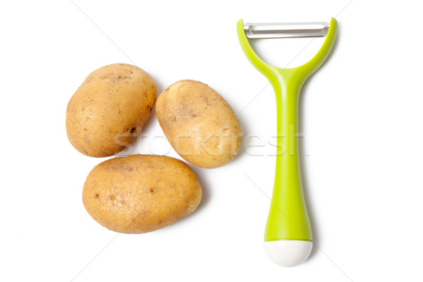 fresh potatoes with vegetable peeler Stock photo © jirkaejc