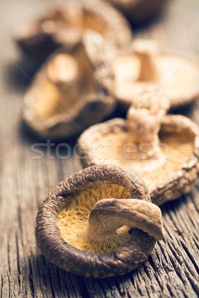 Stock photo: dried shiitake mushrooms on old wooden table