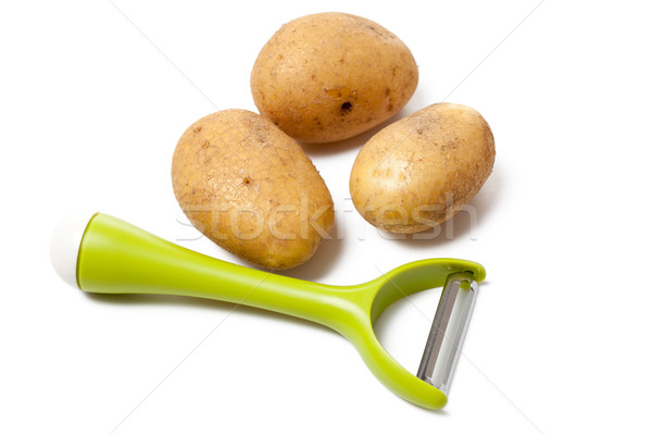 fresh potatoes with vegetable peeler Stock photo © jirkaejc