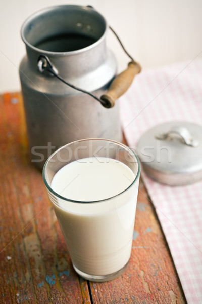 milk in glass on old wooden table Stock photo © jirkaejc