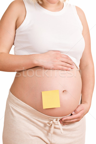 pregnant women with notepaper on her belly Stock photo © jirkaejc
