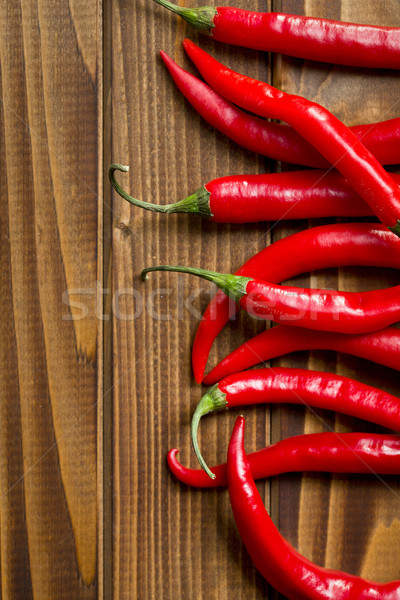 chili peppers on wooden background Stock photo © jirkaejc