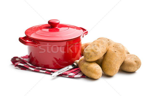 uncooked potatoes and old wooden peeler Stock photo © jirkaejc