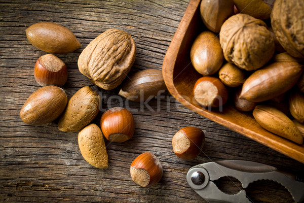 various unpeeled nuts in wooden bowl Stock photo © jirkaejc